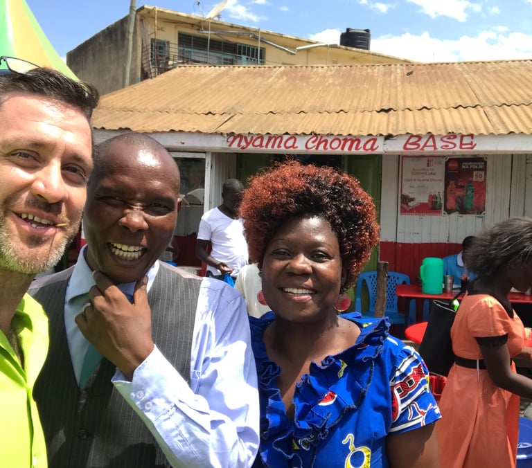 Pastors Shea and Jackson taking a selfie outside a Nyama Choma barbecue restaurant in Kisumu