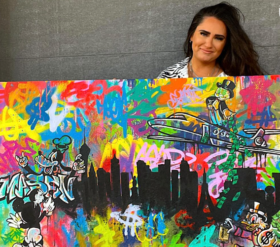 Kamile with her graffiti character painting