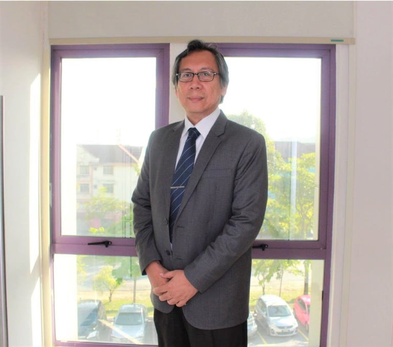 A man in suit standing in front of glass windows