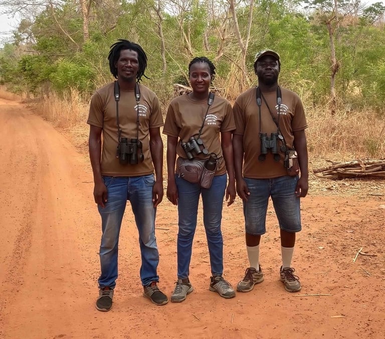 Professional birding guides of Gambia Birding Adventures, with lead guide Fatou Colley standing in t