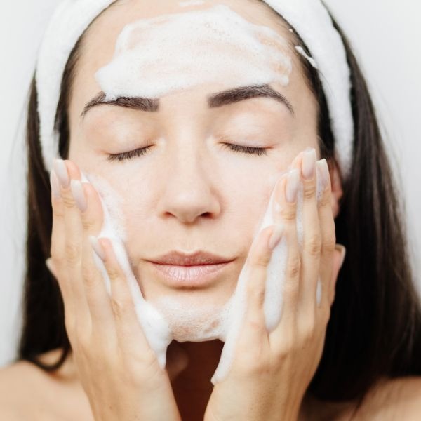 woman cleansing her skin
