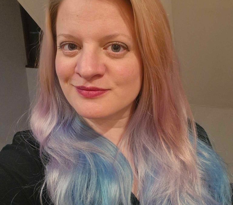 a woman with a blue and white hair and a black shirt