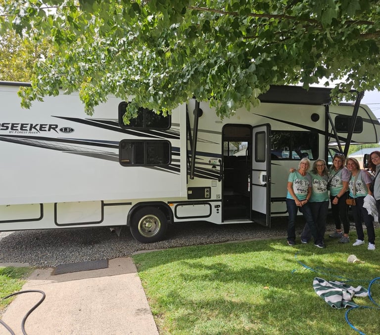 group of ladies in front of RV in matching shirts for their trip