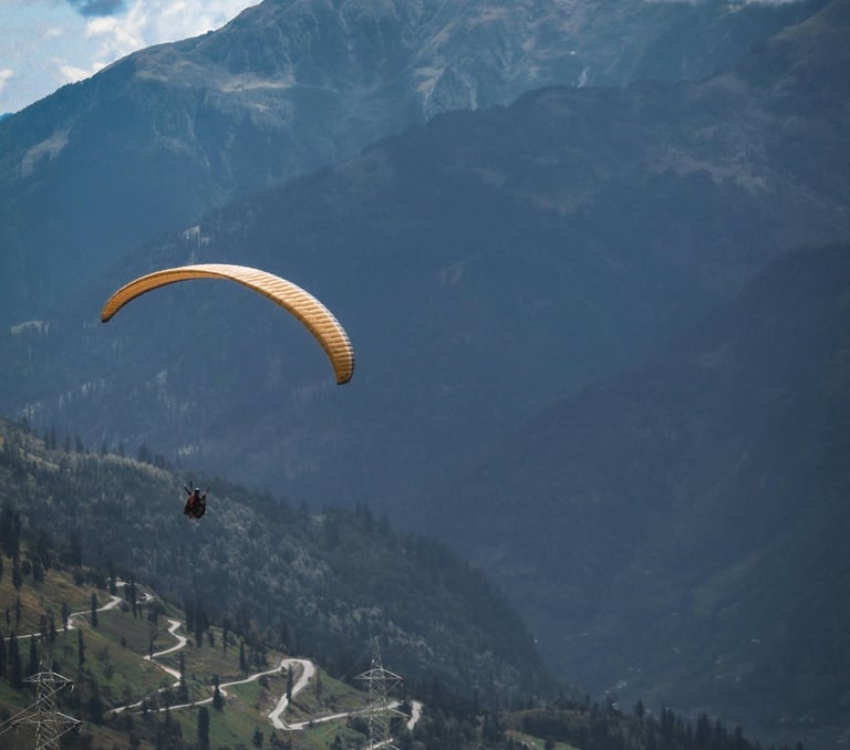 a parasail flying over a mountain