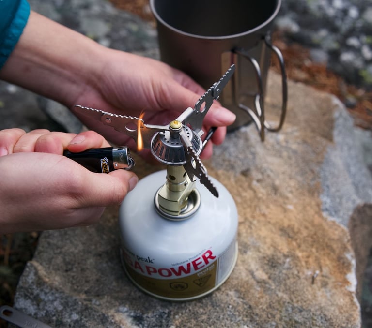 Snow Peak Titanium Backpacking Stove Being Lit With A Lighter