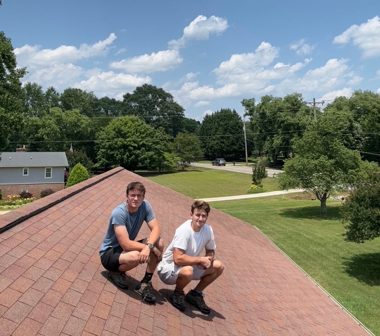 two men sitting on a roof