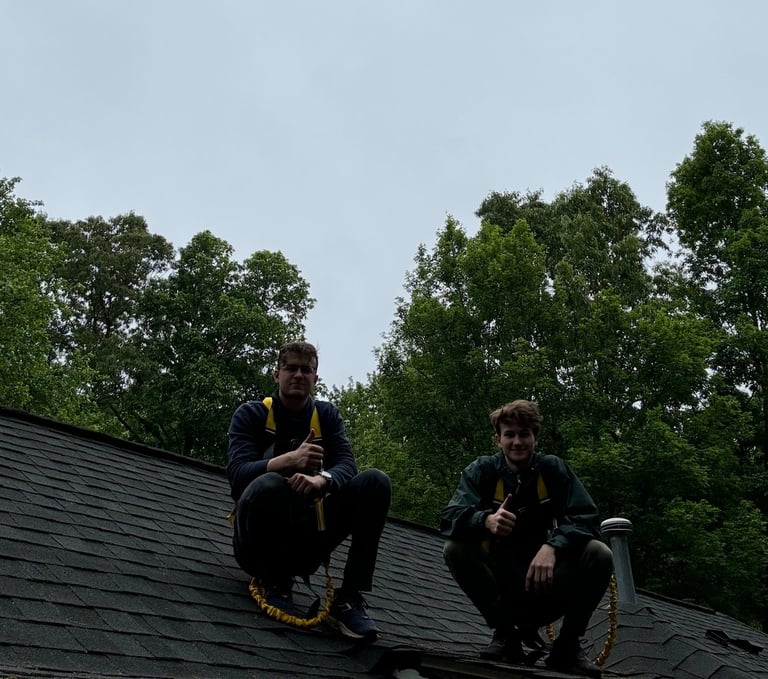 two men sitting on a roof top