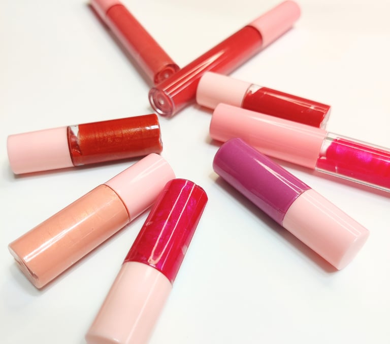 handmade lip glosses laying flat on a white table