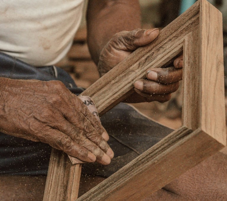 indian wooden artisan sanding a photo frame made of wood