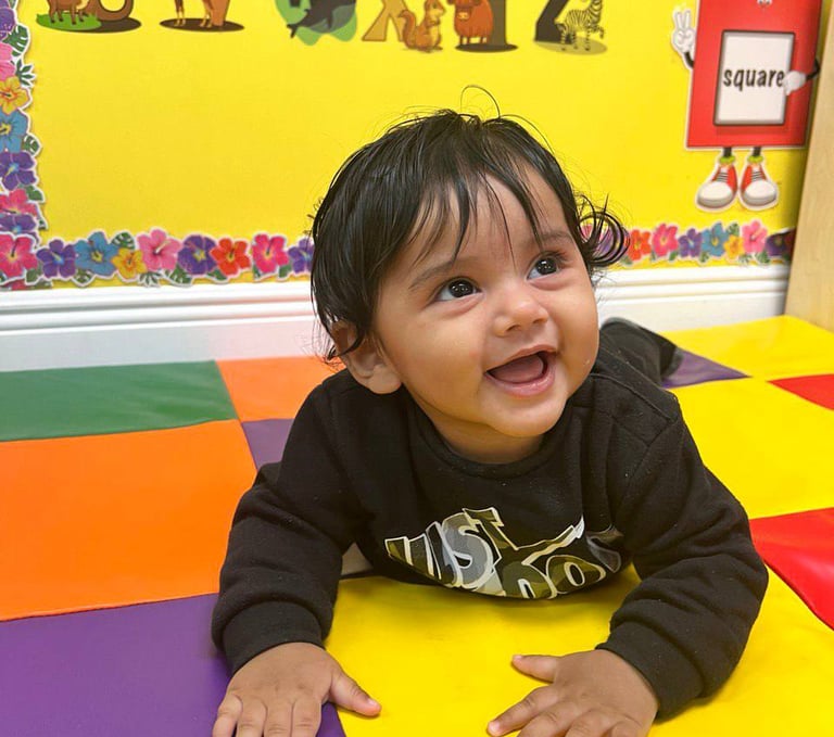 a baby in a play area with a colorful play mat FANTASTIC LAND LEARNING CENTER
