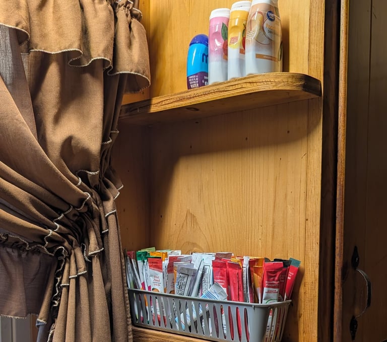 drink packets lined up & organized neatly by a sink