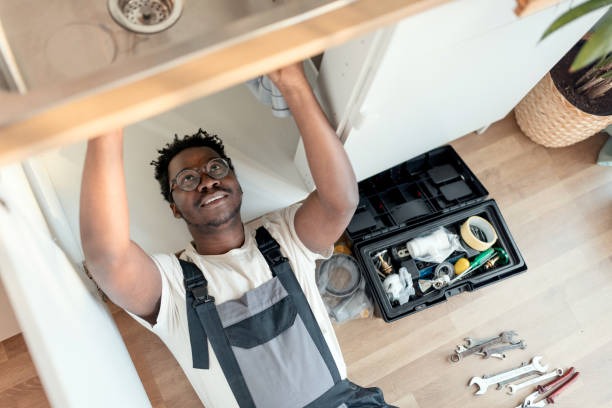 black man working under a sink