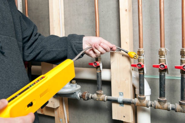 plumber scanning a pipe for leaks
