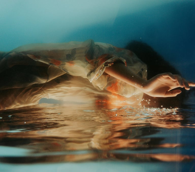 a person holding a hand in the water