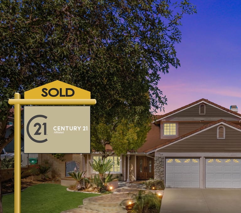 a sold sign in front of a house