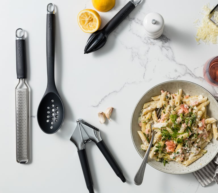 Food product photography - a bowl of pasta with a glass and utensils