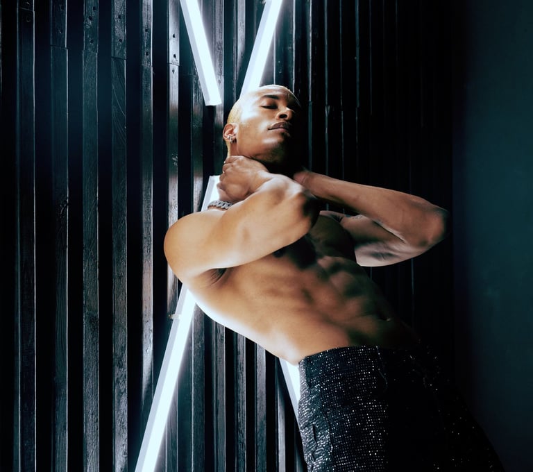 Roy Covington shirtless leaning against the wall