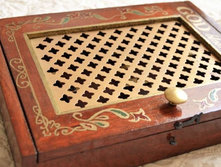 a wooden box with a golden handle