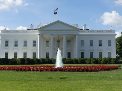 white house - a large white house with a fountain in front of it