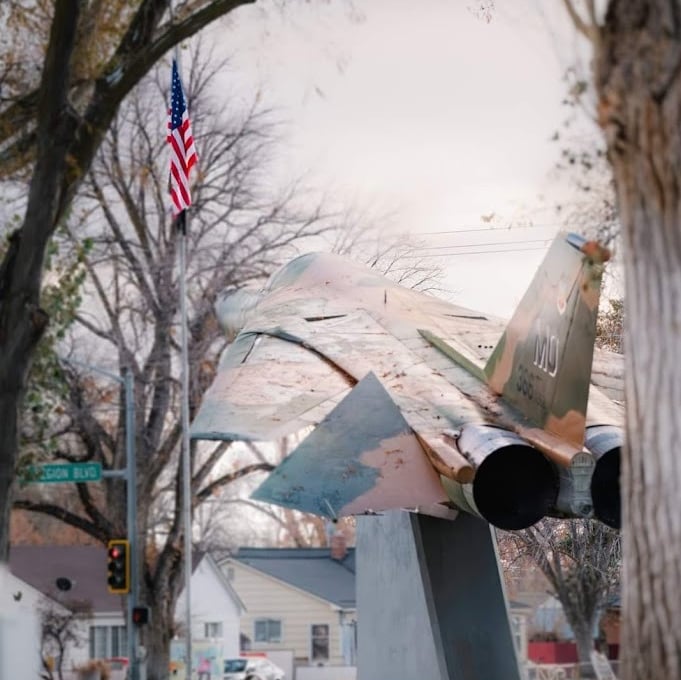 Jet display in Mountain Home Idaho with an American flag.