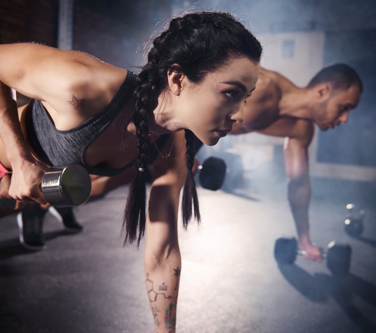 A lady and a man working out at gym 