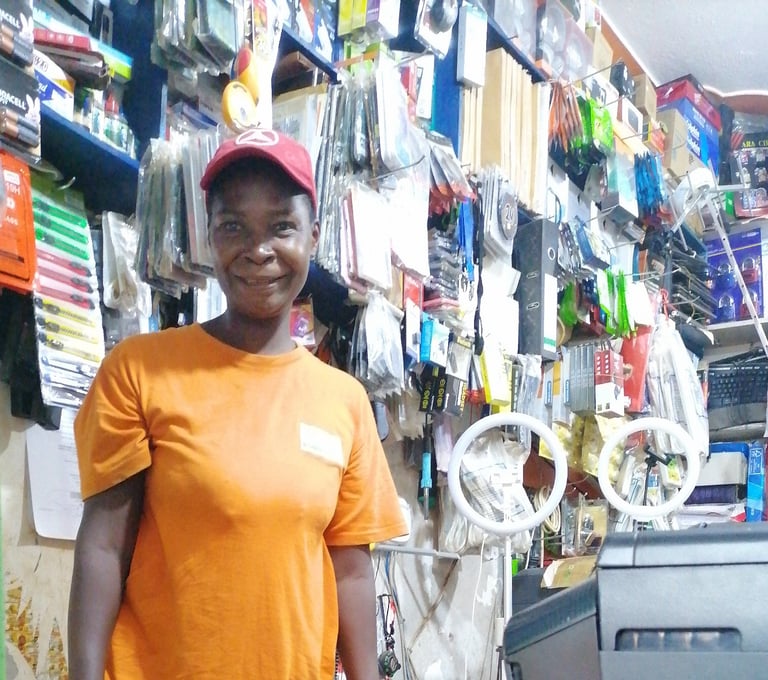 a woman in a orange shirt and a red hat