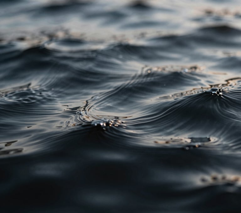 Macro photography of ripples in dark water, capturing a liquid texture that looks like brushed metal. The lighting highlights the peaks in #D0D5DB against deep #0A0A0C shadows.