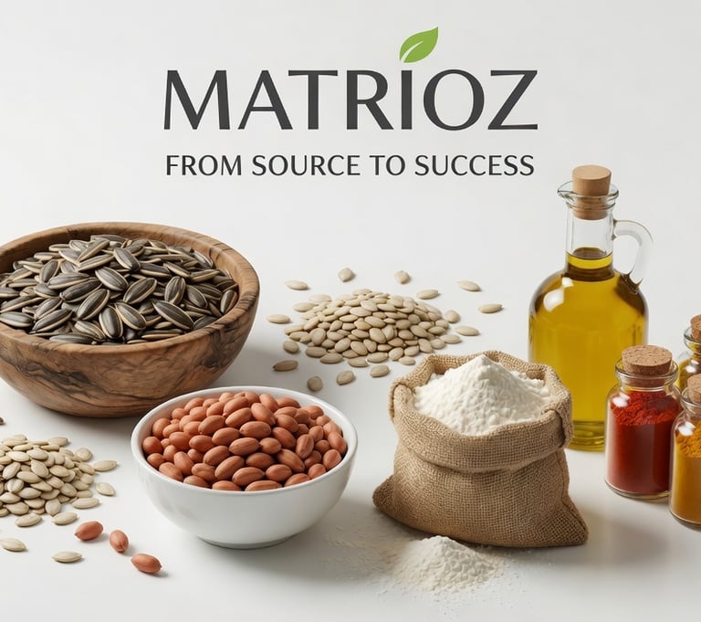 A selection of raw sunflower seeds, peanuts, flour, spices, and olive oil for food manufacturing.