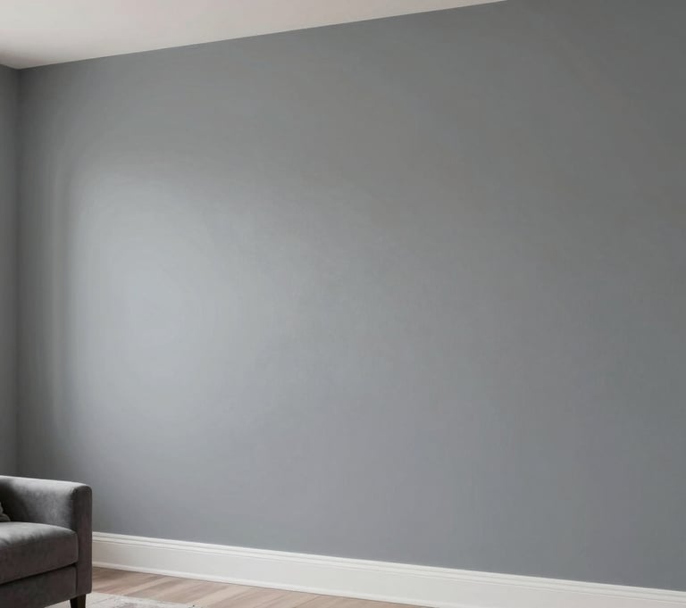 A professionally painted modern living room wall in a soft steel gray. The lighting is soft and natural from a side window, highlighting the smooth, flawless texture of the finish. North American / Hispanic interior styling with elegant minimalist decor.