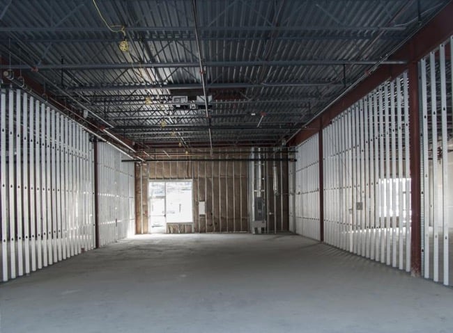 a large open space with a metal structure and a metal structure designed by Houston commercial contr