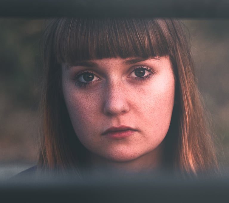 close up of a women with long hair and visible freckles