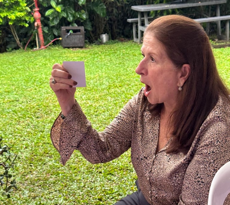 a woman holding a card and taking a selfie