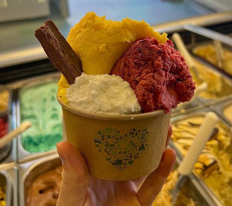 A pot with 3 scoops of ice crteam and a flake.