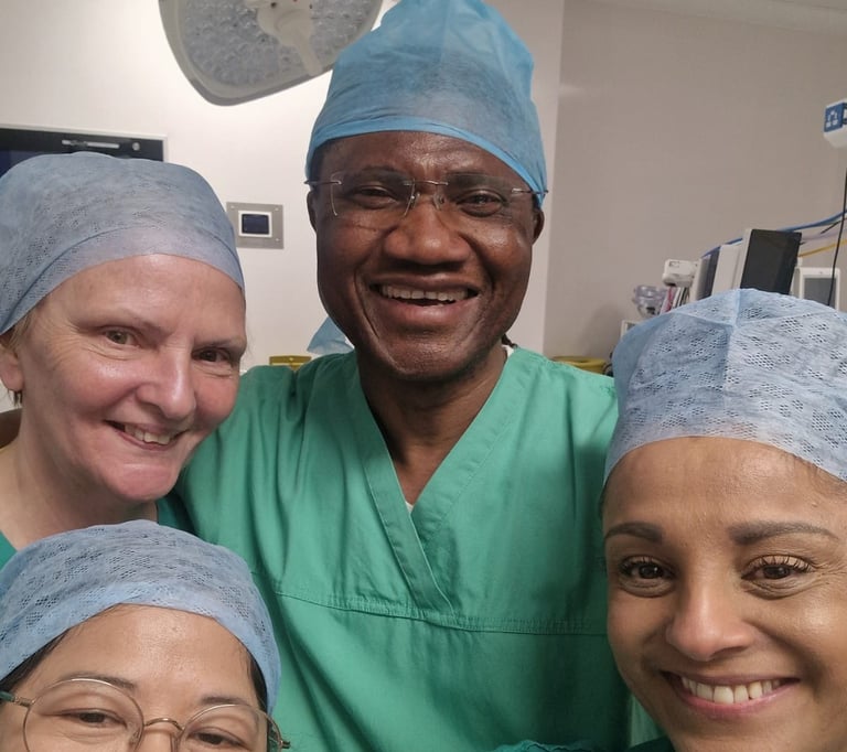 Mr Onwudike (centre) in surgical scrubs, surrounded by his medical team in a selfie