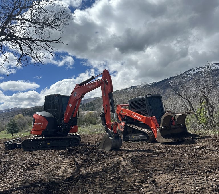 Kubota KX057-s excavator and Kubota skid steer sitting idle on dirt project