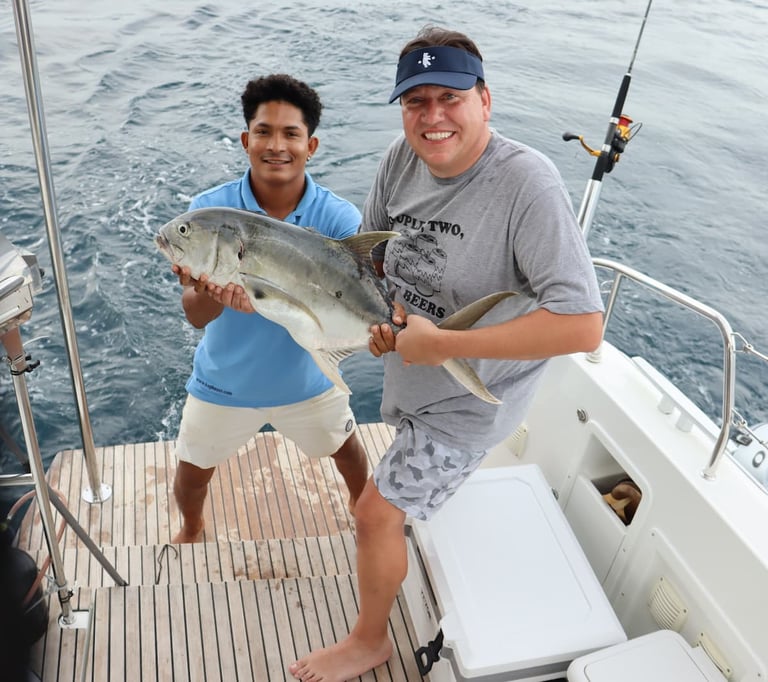 Happy guest with caught fish during sport fishing experience in Gulf of Papagayo, Costa Rica