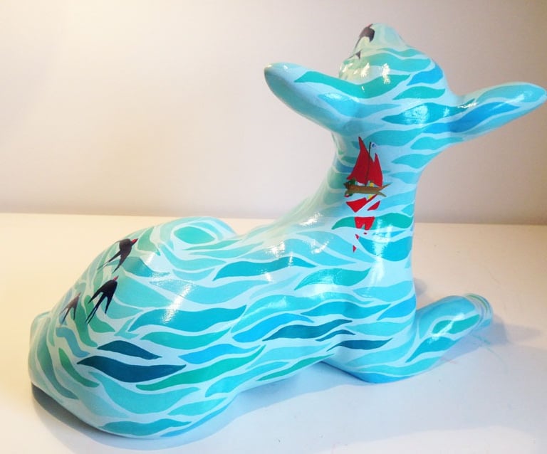 Small sculpture of a lamb featuring a Swallows and Amazons design by Laura Fearn
