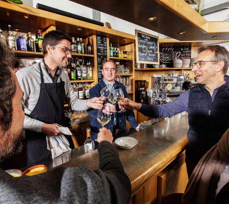 a group of people standing around a bar
