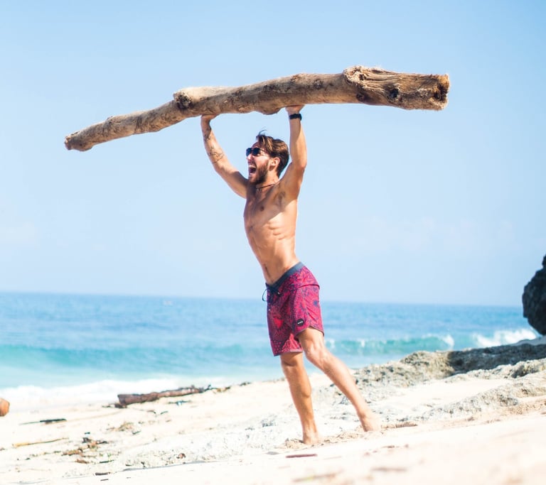 a strong man lifting a large heavy piece of wood in his hands