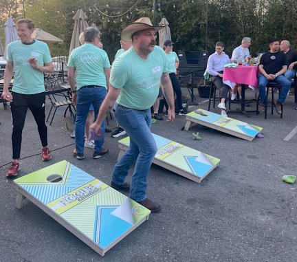Mr. ASGRA 2026, Duke, tosses a cornhole bean bag