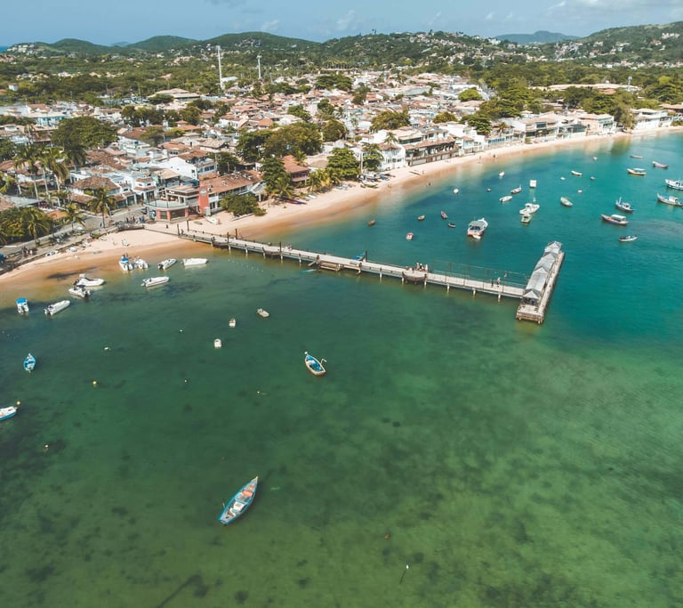 a pier with boats and a pier in the background in Buzios, Rio de janeiro, Brazil