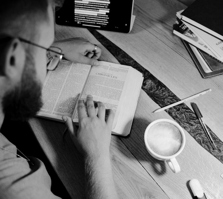 a man sitting at a desk with a cup of coffee