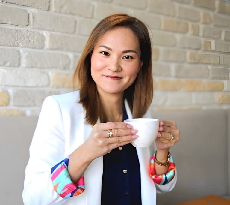 a Japanese woman in a white blazer drinking coffee