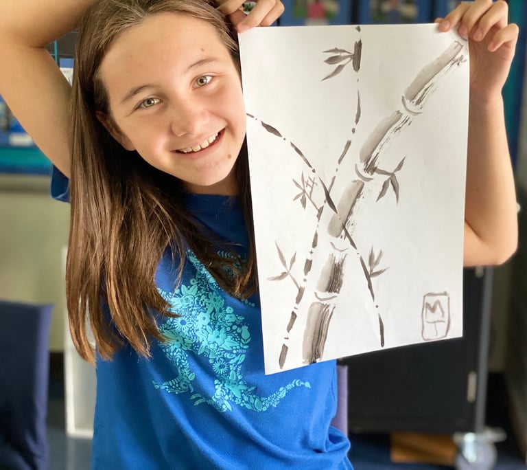 student demonstrating a brush painting