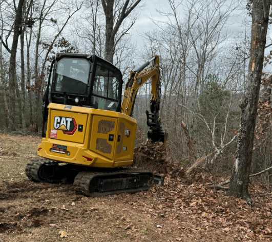 CAT excavator digging up dirt