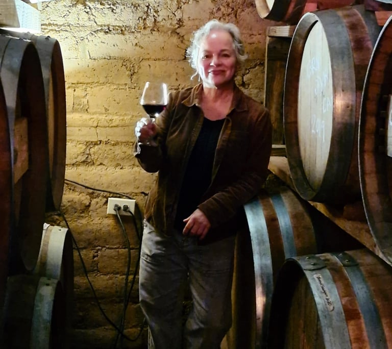 Sitara with wine barrels in her cava at Valle Girl Vino