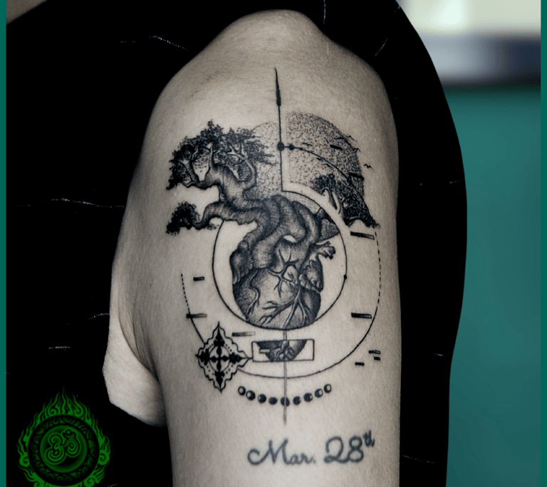 Graphic tree tattoo on the upper arm