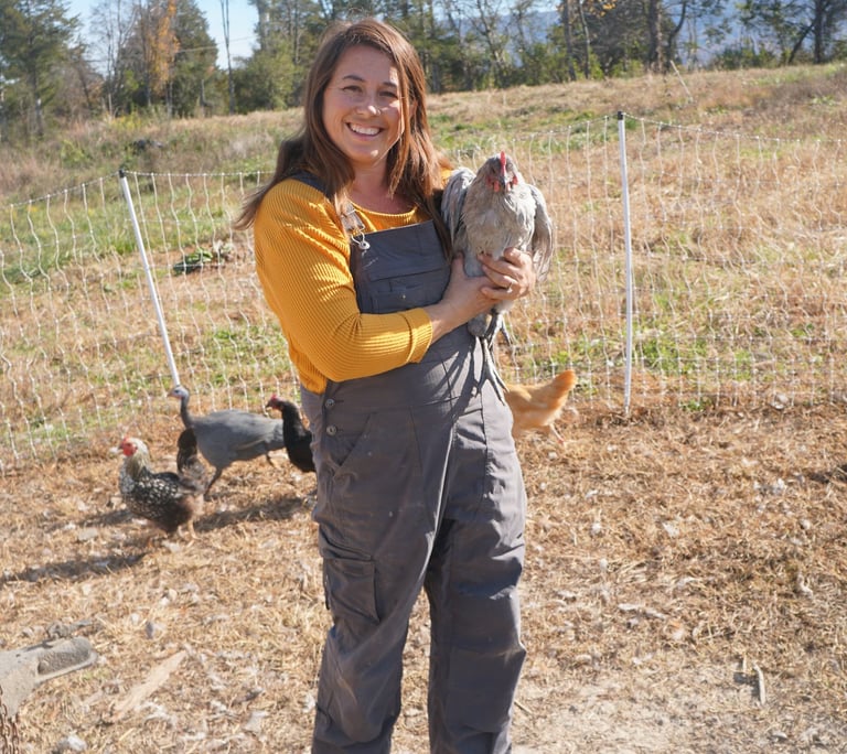 owner holding chicken 