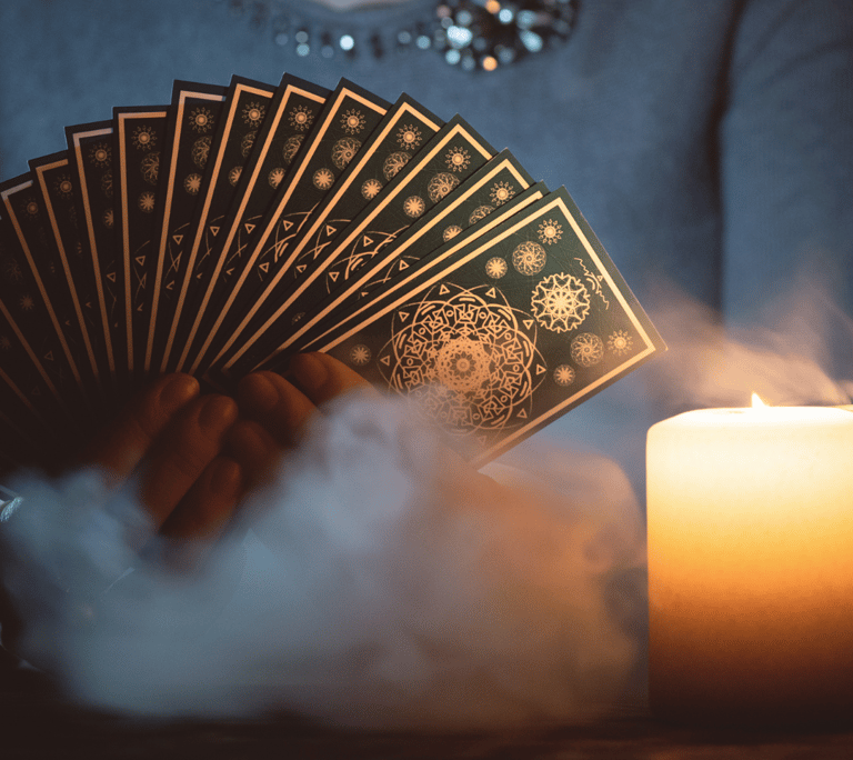 a woman holding a card game of cards and a candle