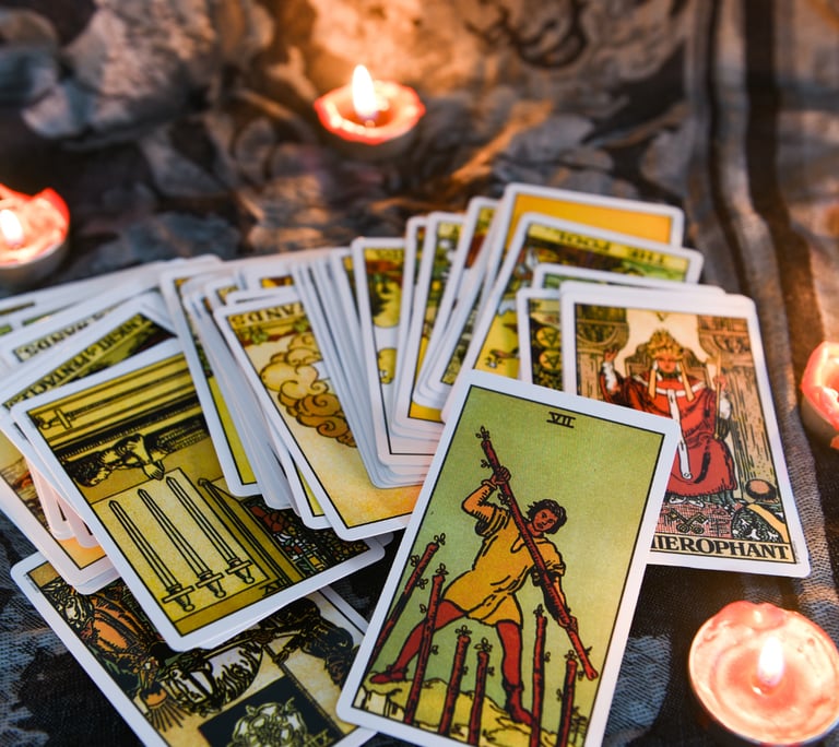 a bunch of tarot cards with candles and candles